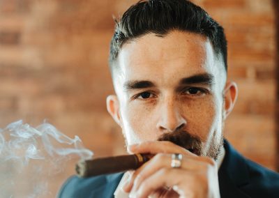 groom smoking lit cigar