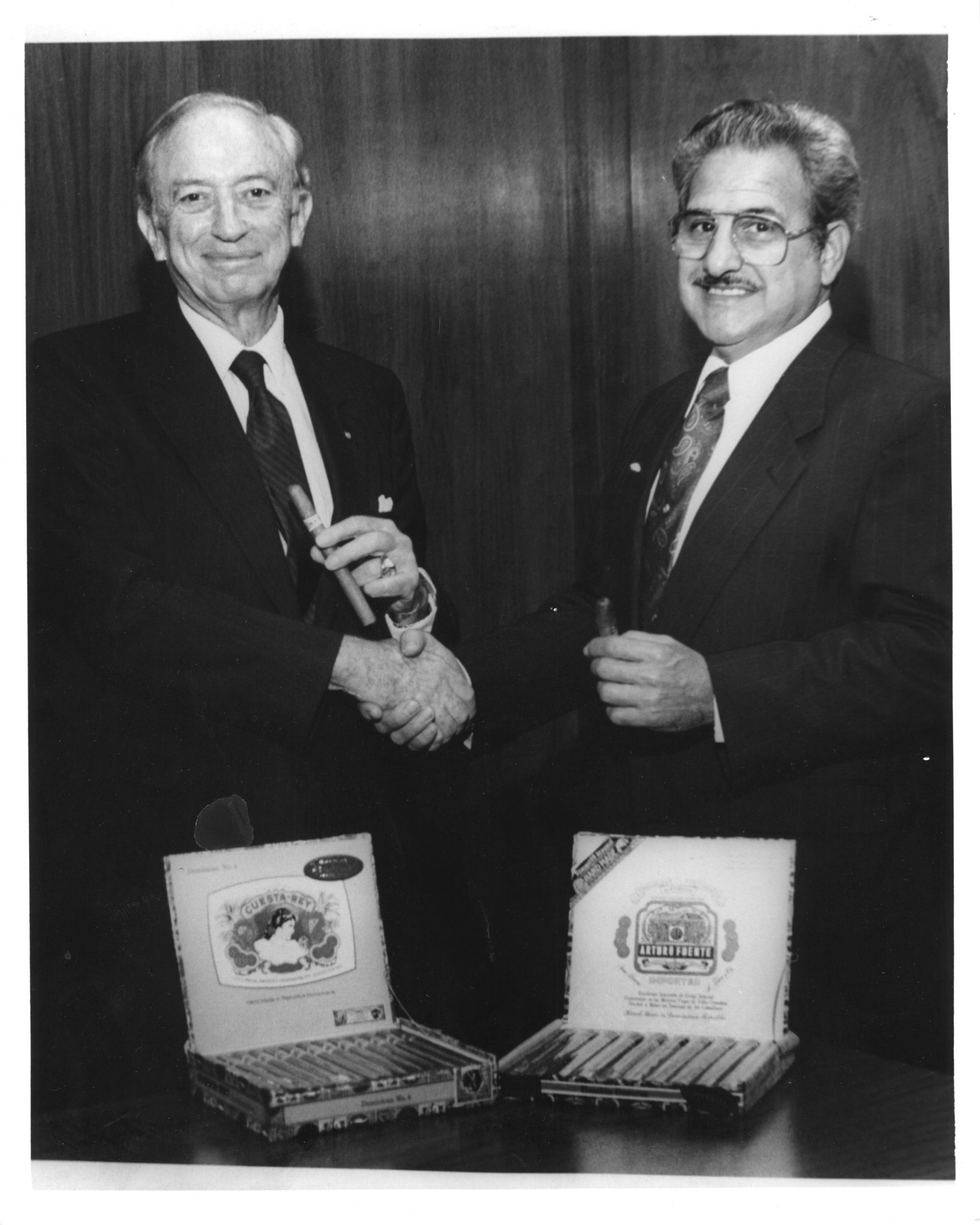 Carlos Fuente Sr. and Stanford Newman Shake Hands over cigar boxes