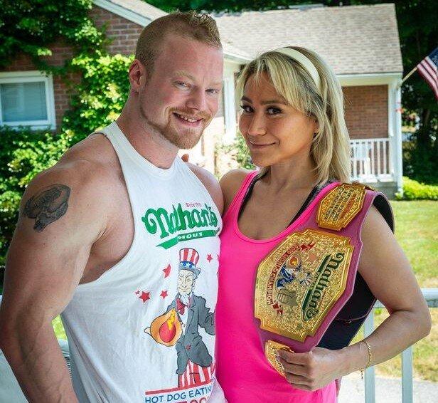 miki and nick posing with her nathans hotdog championship belt